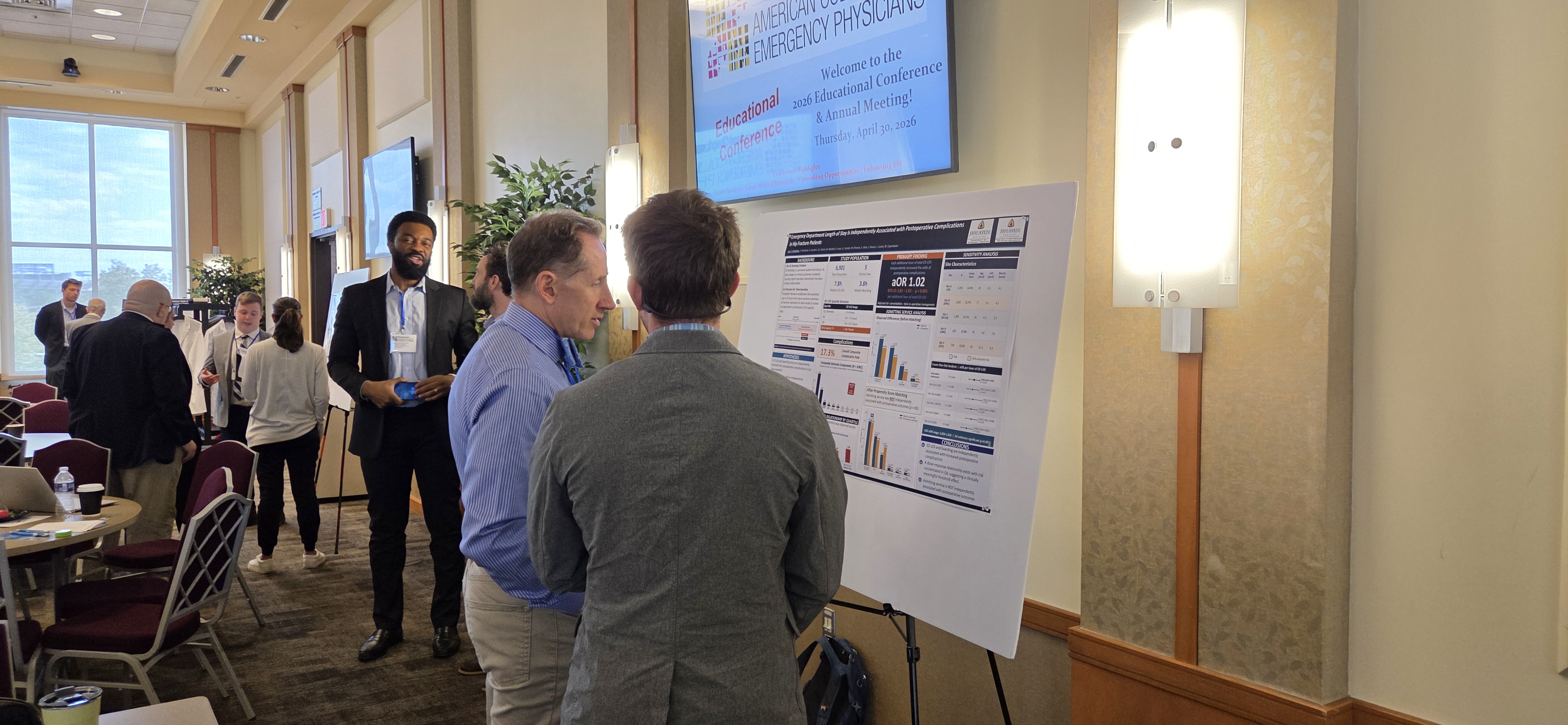 Dr. Schenkel reviews a poster presentation at the 2026 ACEP Conference