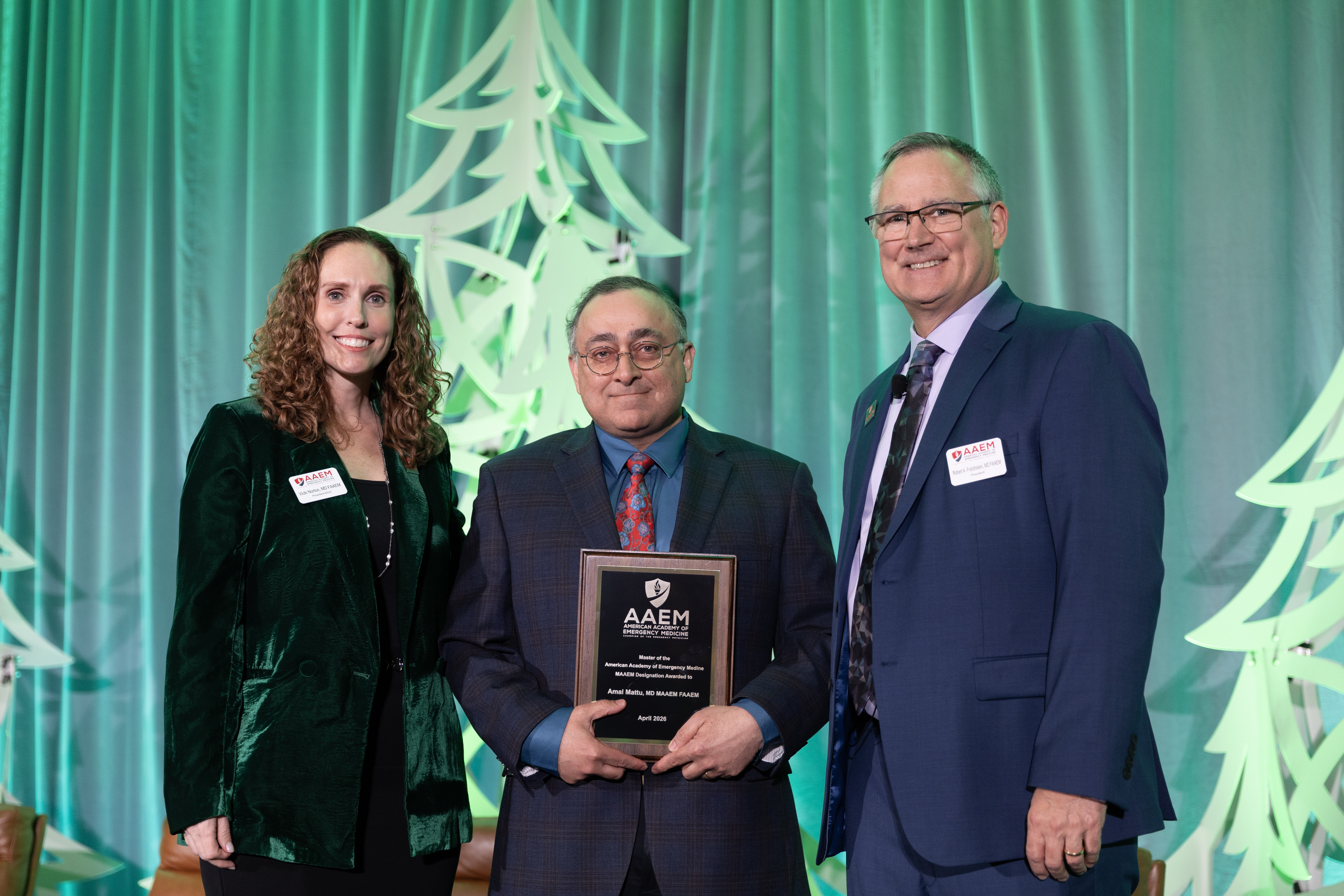 Dr. Mattu receiving award alongside AAEM leaders